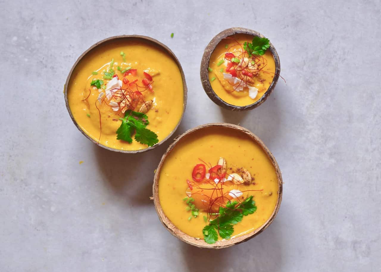 Coconut Curry Pumpkin Soup served in coconut bowls