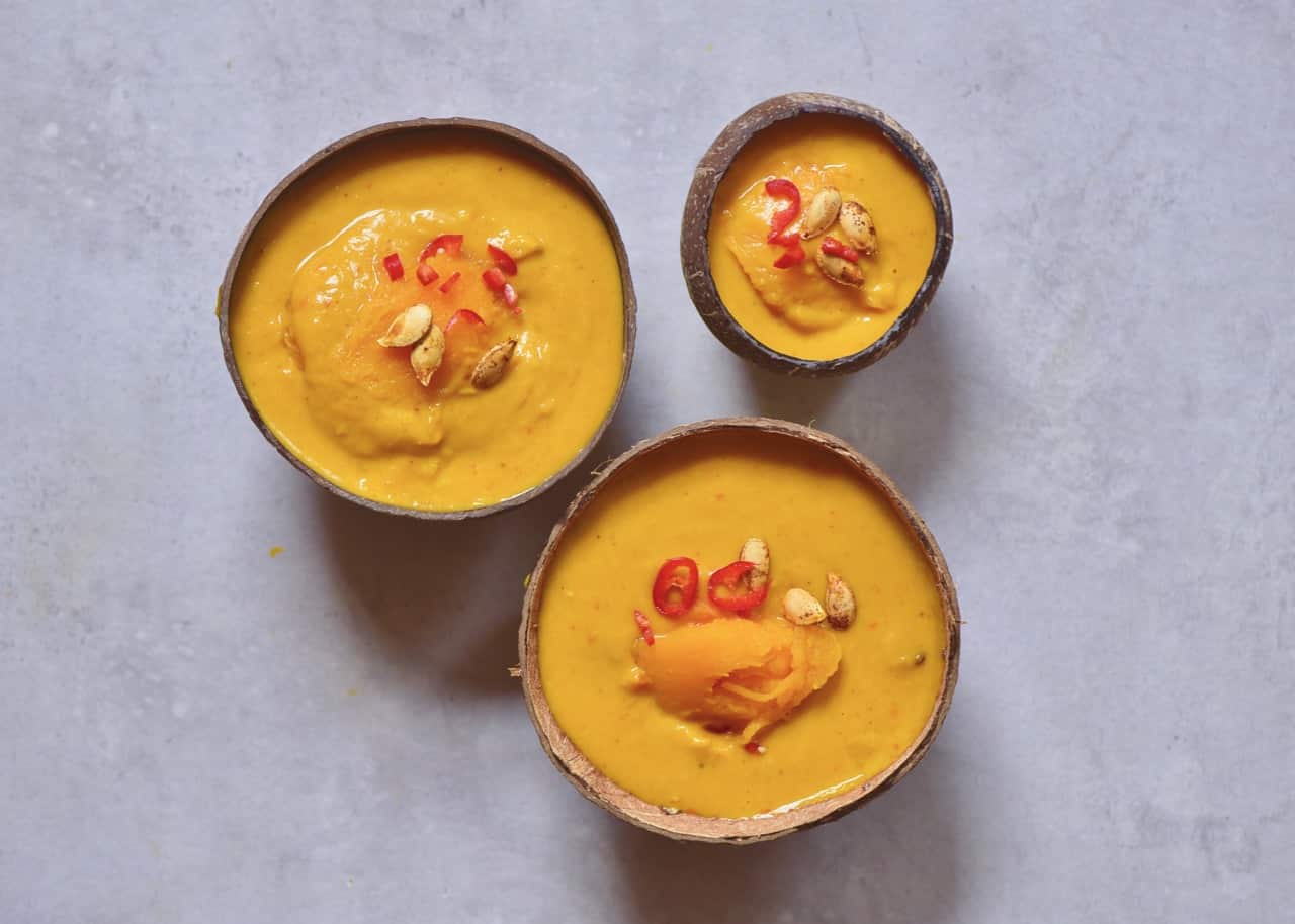 Pumpkin Coconut Curry Soup served in coconut bowls