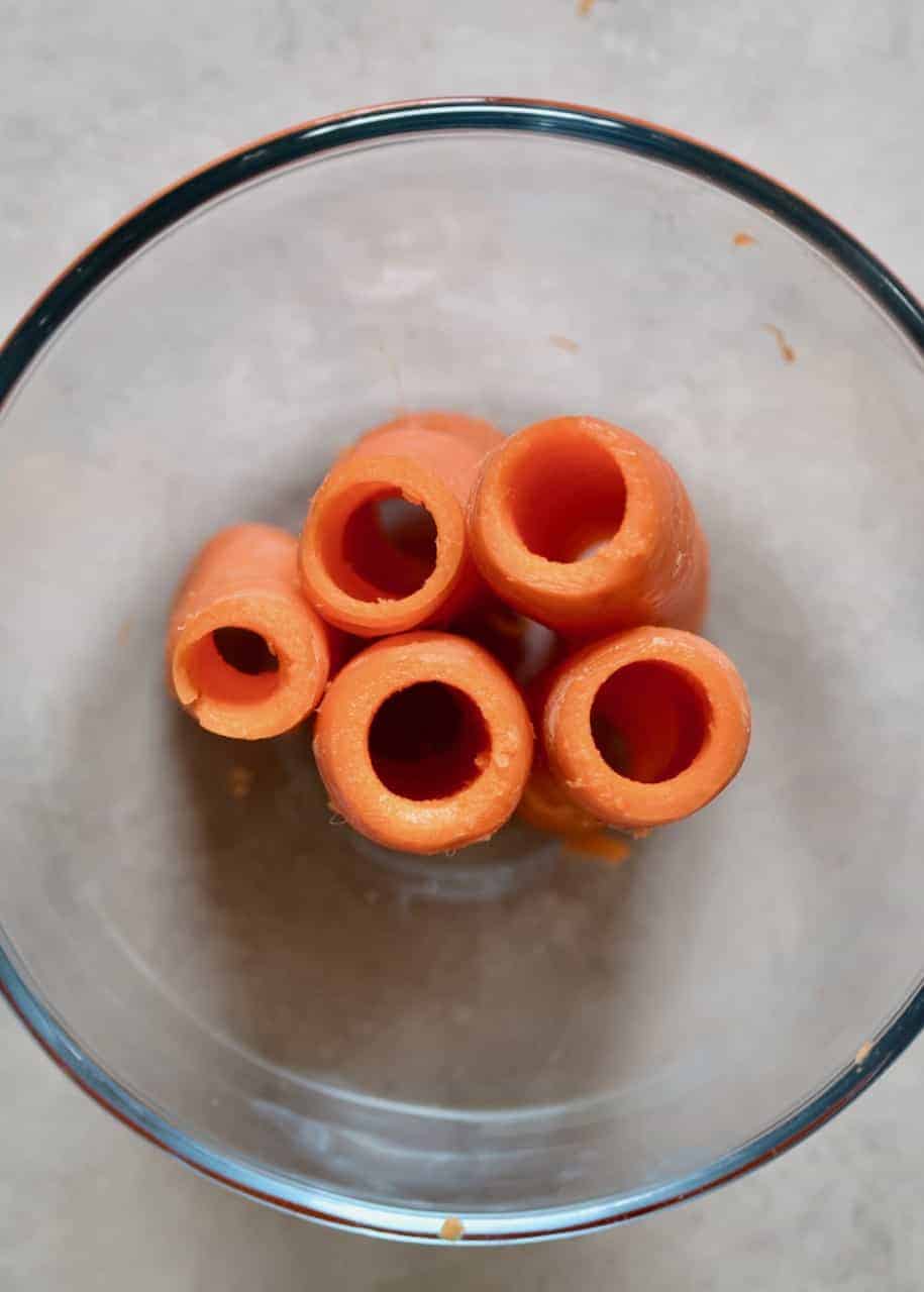 A bowl with five cored carrots