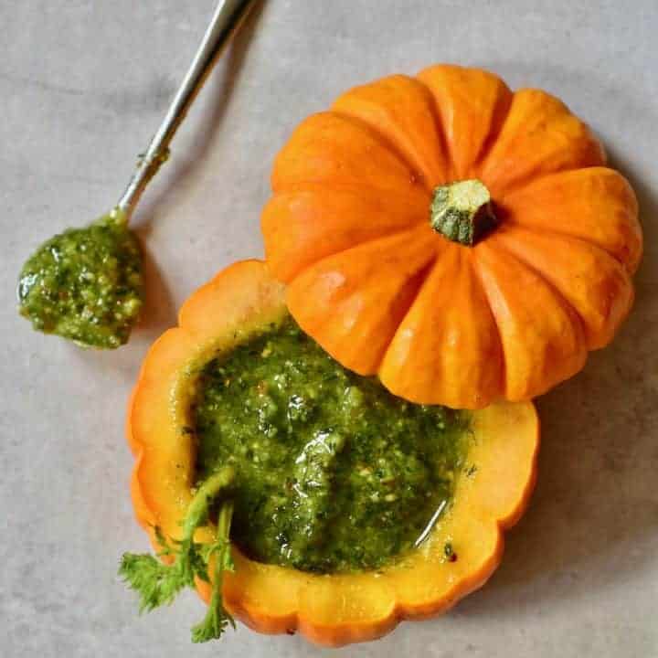 A mini pumpkin filled with green pesto