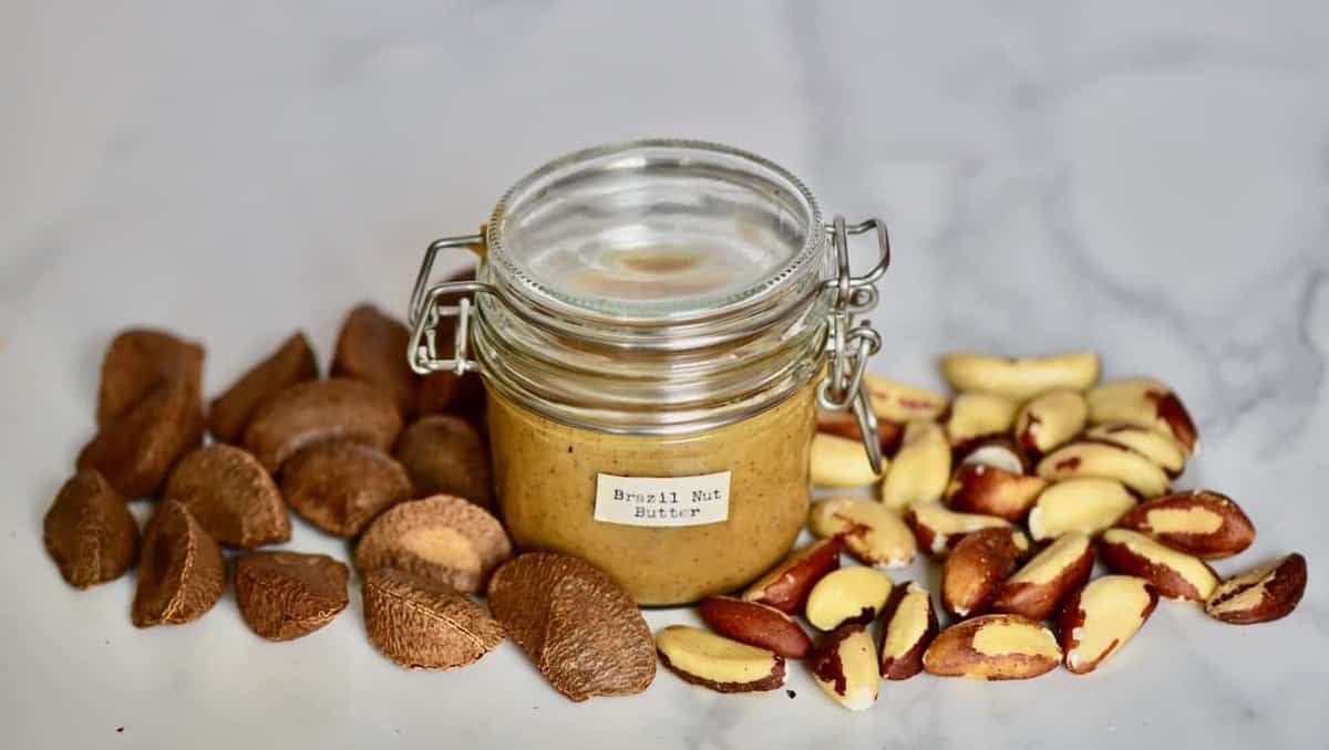 homemade brazil nut butter in a jar and brazil nuts next to it