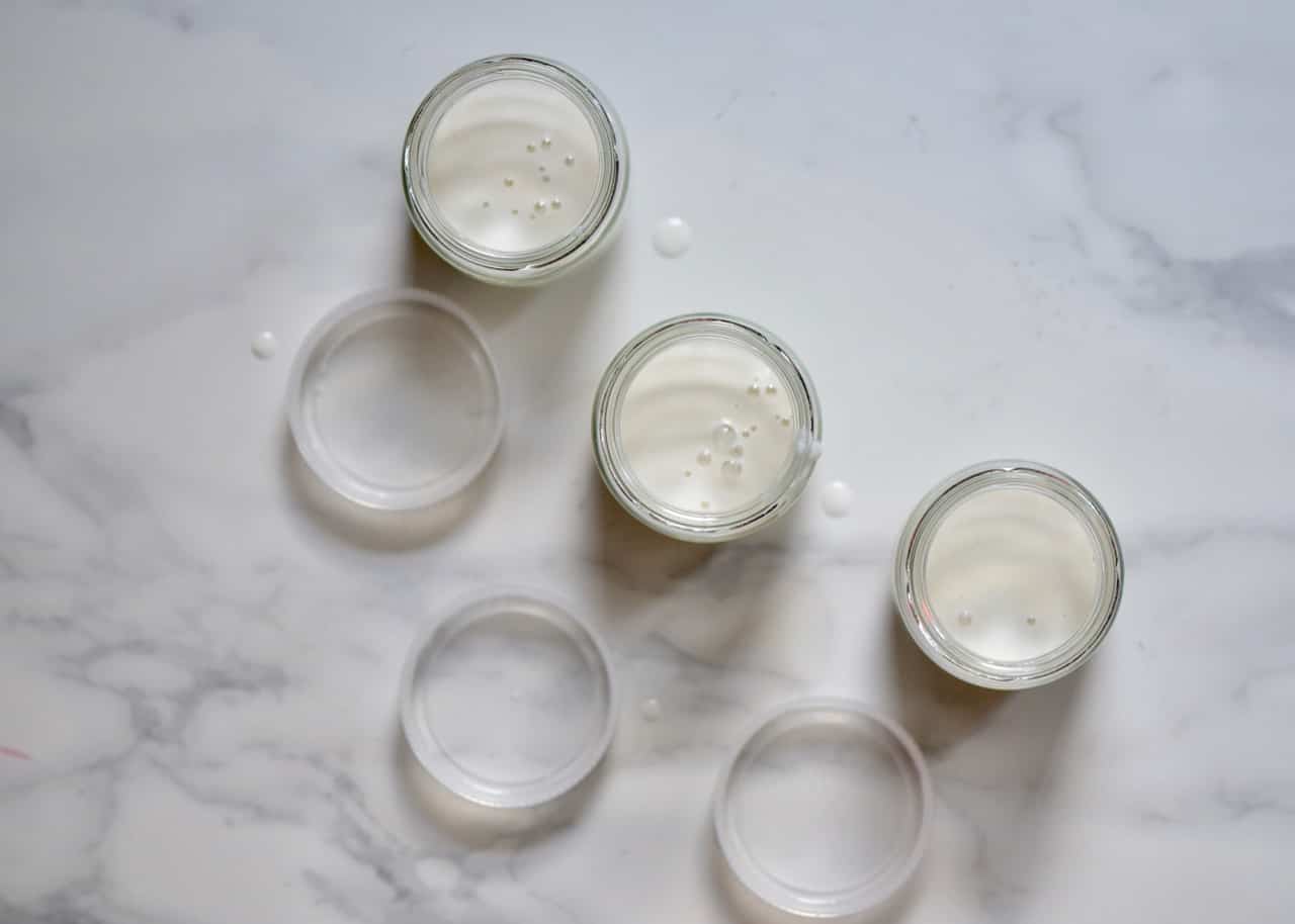 Filling little jars with homemade coconut yogurt