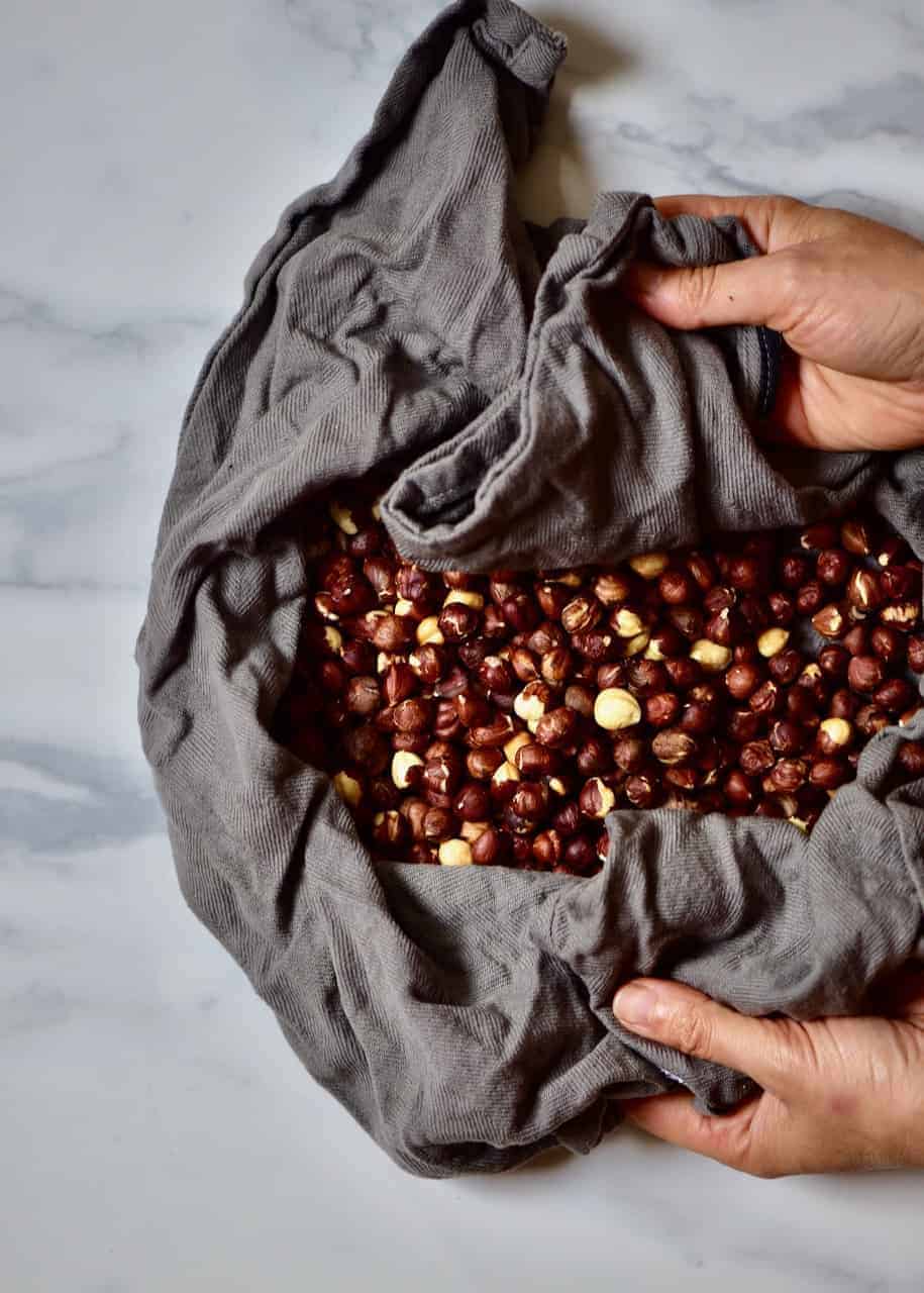removing skins from hazelnuts in a kitchen towel