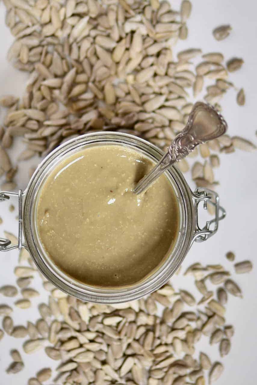 top view of a jar with sunflower butter and a spoon