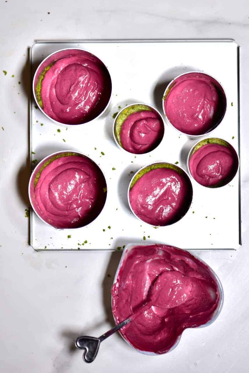 Delicious ombre pink and green raw vegan no-bake cheesecake with a gluten-free pistachio base and cashew nut based cherry cheesecake filling!