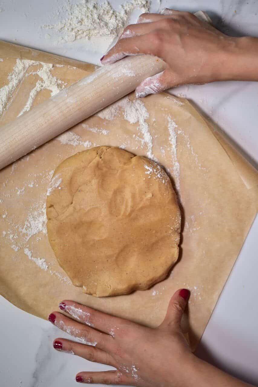 rolling out dough for a christmas gingerbread house