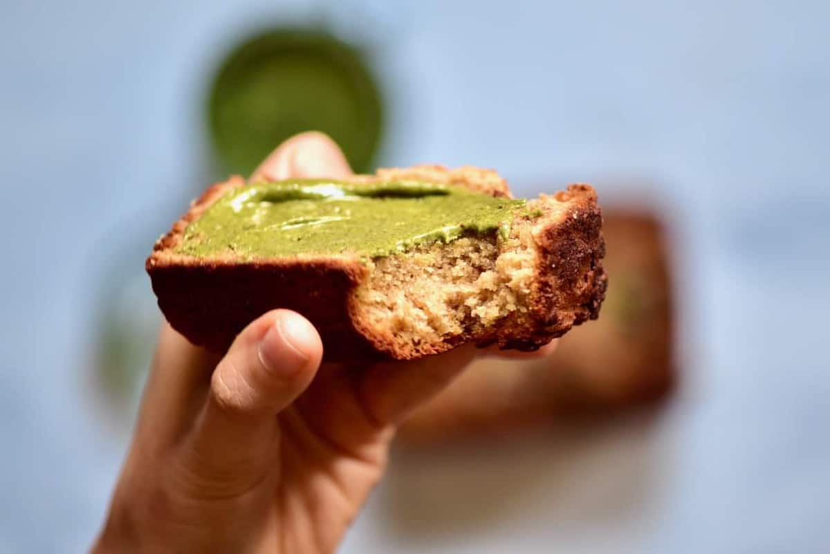 A piece of banana bread topped with pumpkin seed butter
