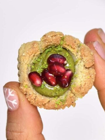 Delicious gluten-free, vegan bite-size snacks; almond & pistachio thumbprint cookies recipe. Not only are they easy to make- they can either be baked or kept as a no-bake cookie recipe!
