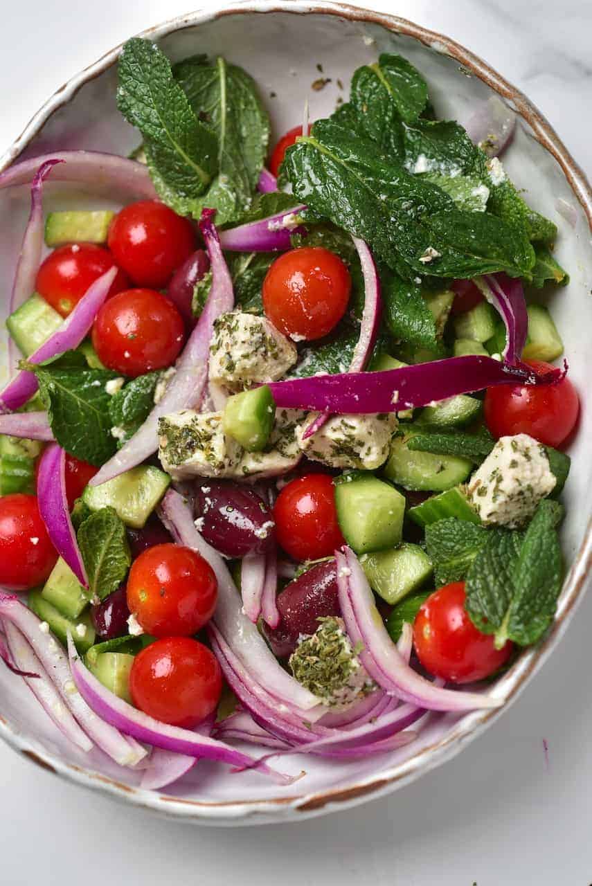 A delicious vegan feta cheese Greek Salad in a bowl