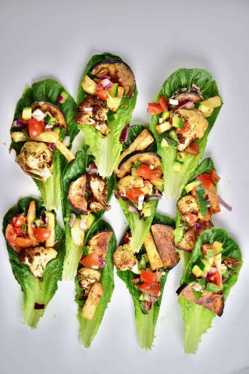 a few lettuce wraps topped with veggies 