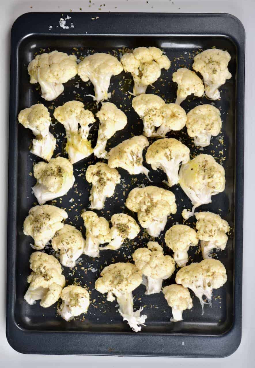 cauliflower on oven tray, ready to be baked with olive oil and oregano