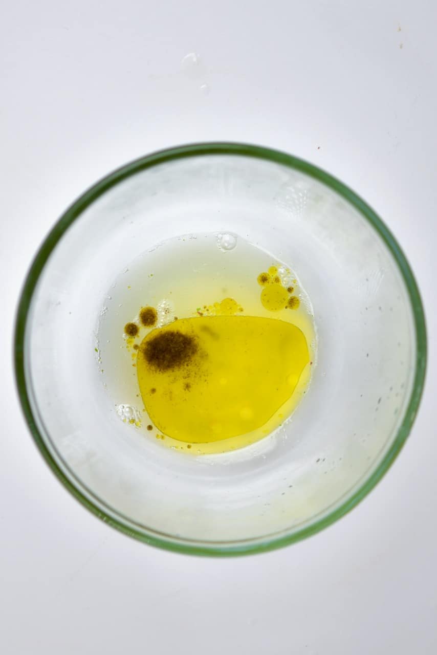 homemade lemon juice and olive oil salad dressing in a bowl