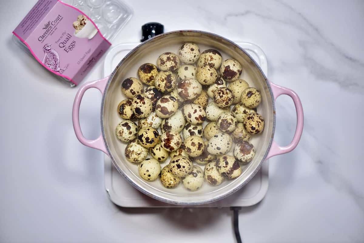 Clarence court quail eggs in a large pot of boiling water