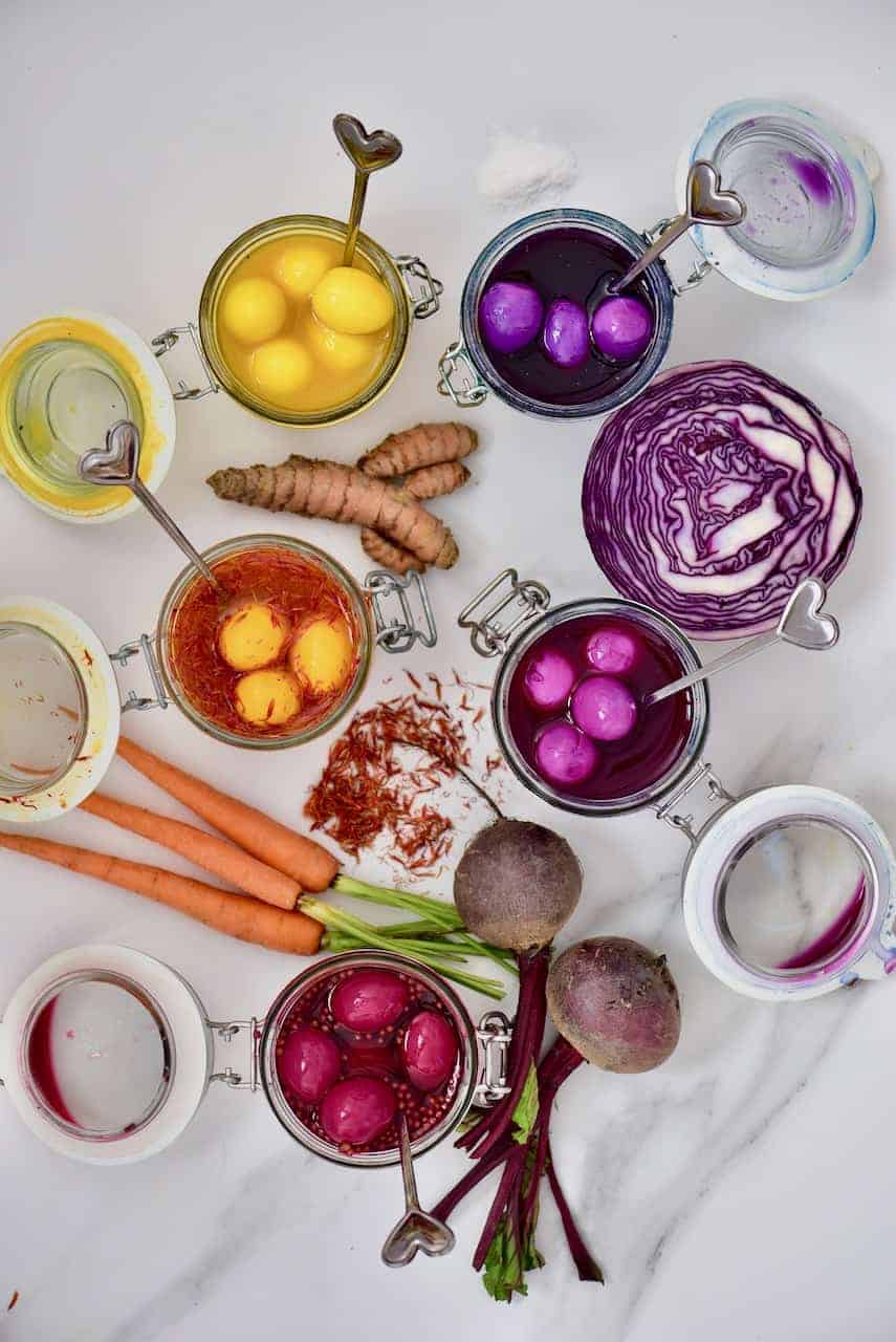 naturally dyed rainbow pickled quail eggs in their pickling liquid 