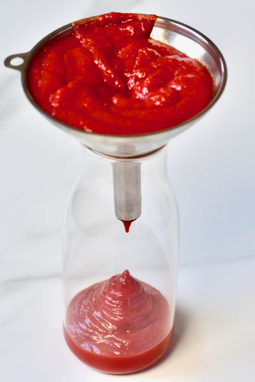 Adding homemade ketchup in a bottle