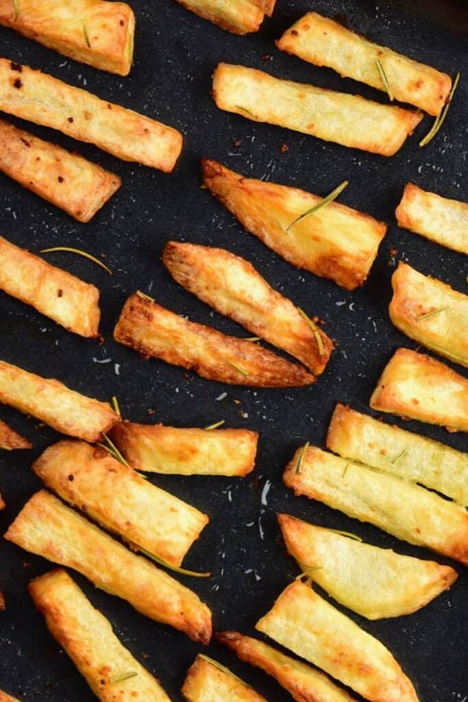 Crispy baked fries on a black tray