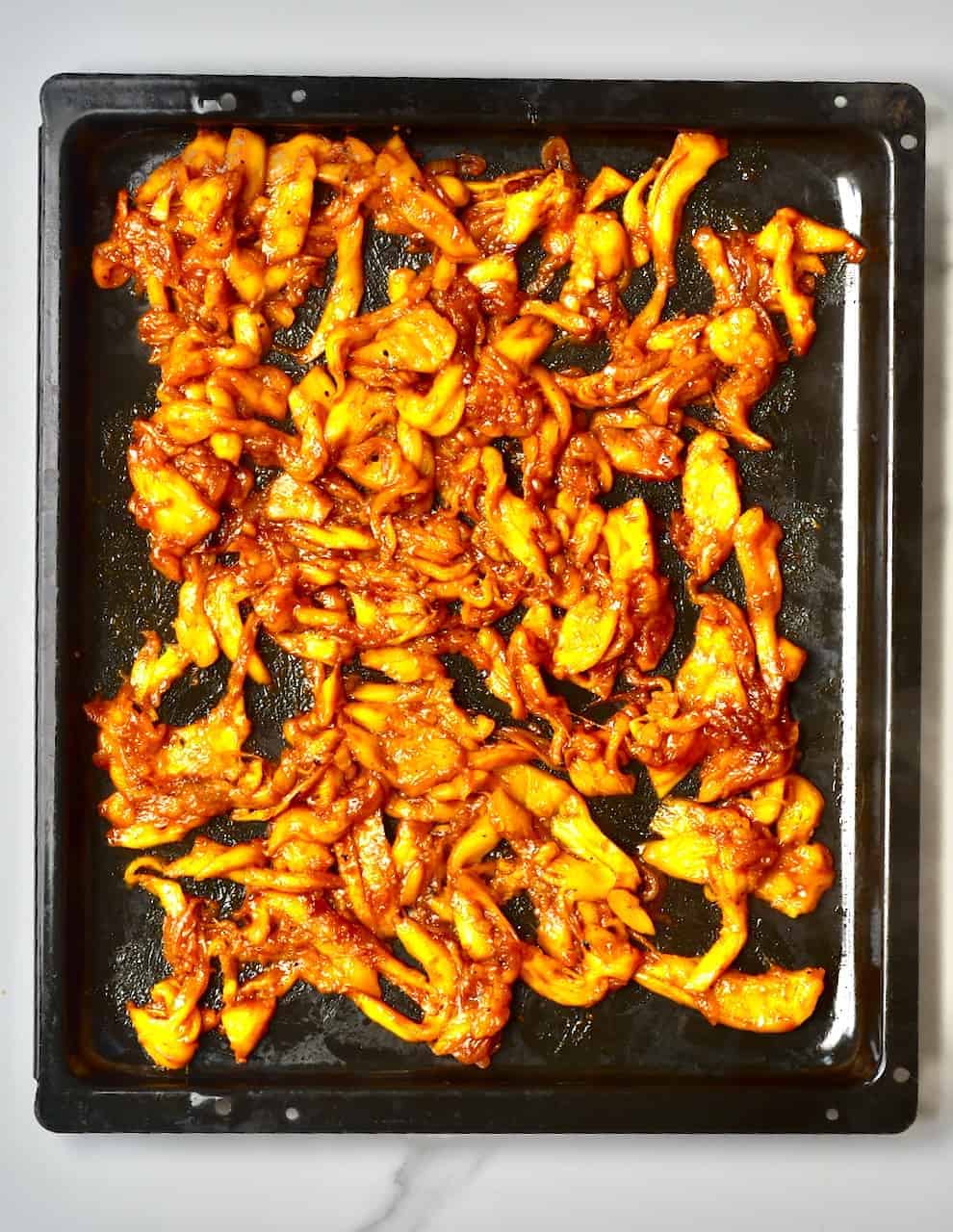 Cooked jackfruit on tray - delicious bbq pulled jackfruit recipe