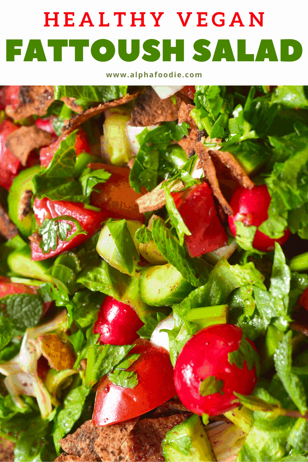 A close up of fattoush salad with mint cucumber tomatoes and toasted pita bread
