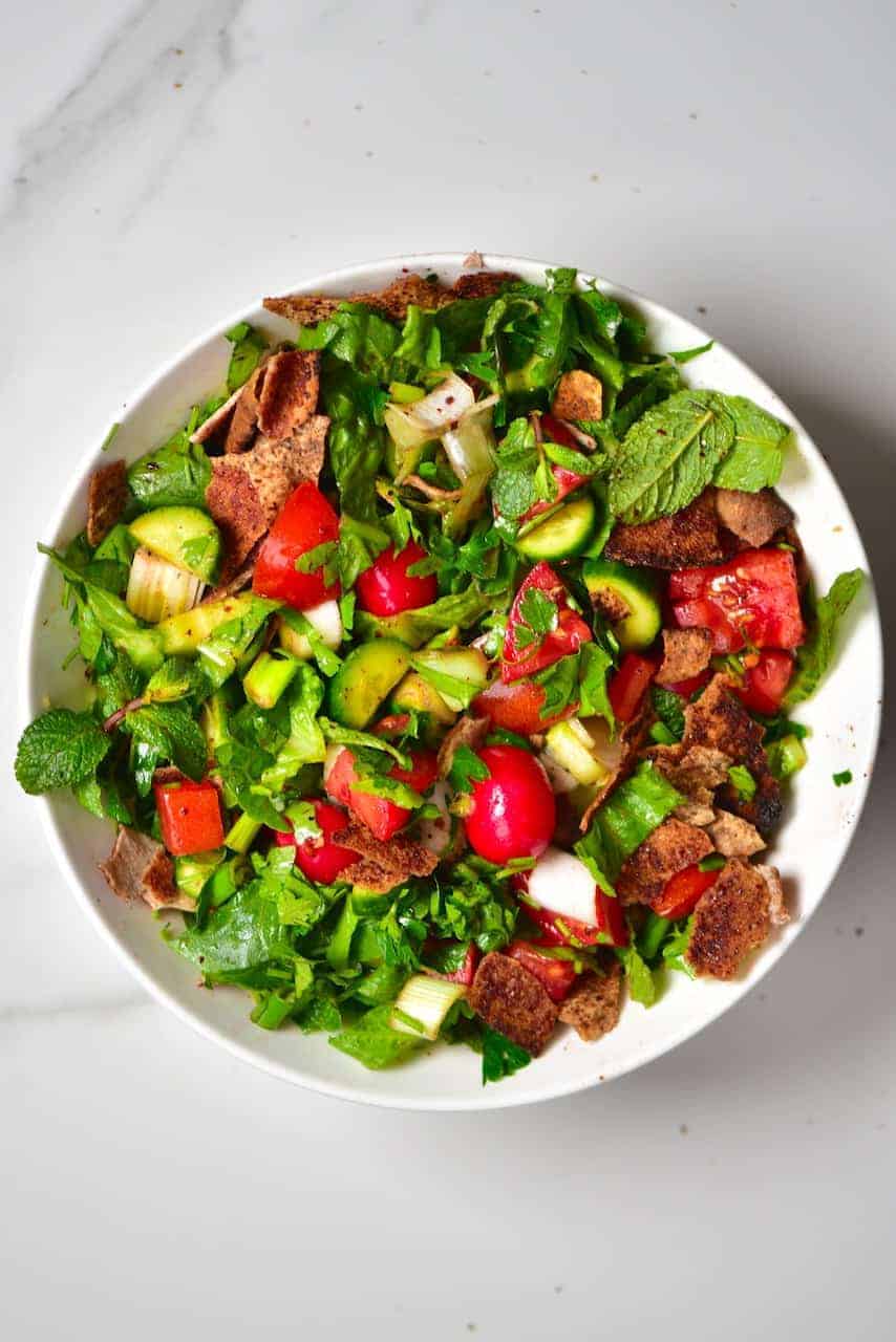 A simple traditional Lebanese fattoush salad ( bread salad) with a mixture of salad vegetables, toasted pita bread and a delicious pomegranate salad dressing, for a quick, healthy meal
