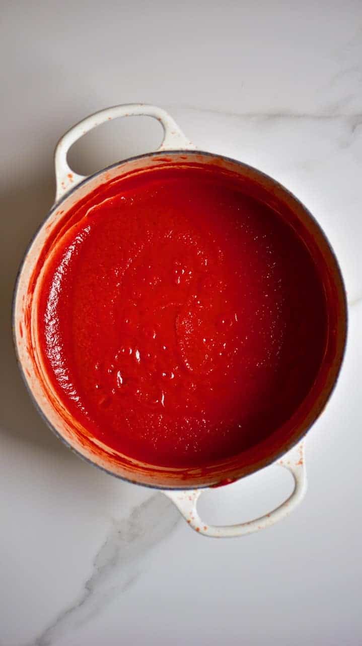 homemade ketchup in a large pan. A simple DIY for how to make ketchup at home- the perfect tomato ketchup recipe
