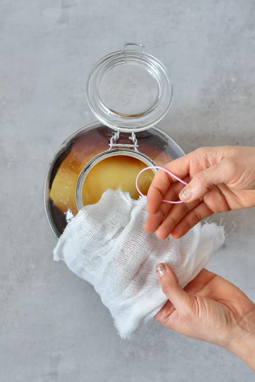 securing material to the top of your homemade kombucha jar