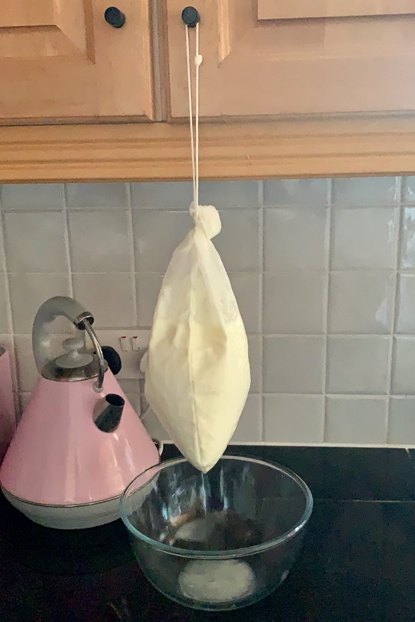 draining yogurt in a nut milk bag - how to make labneh