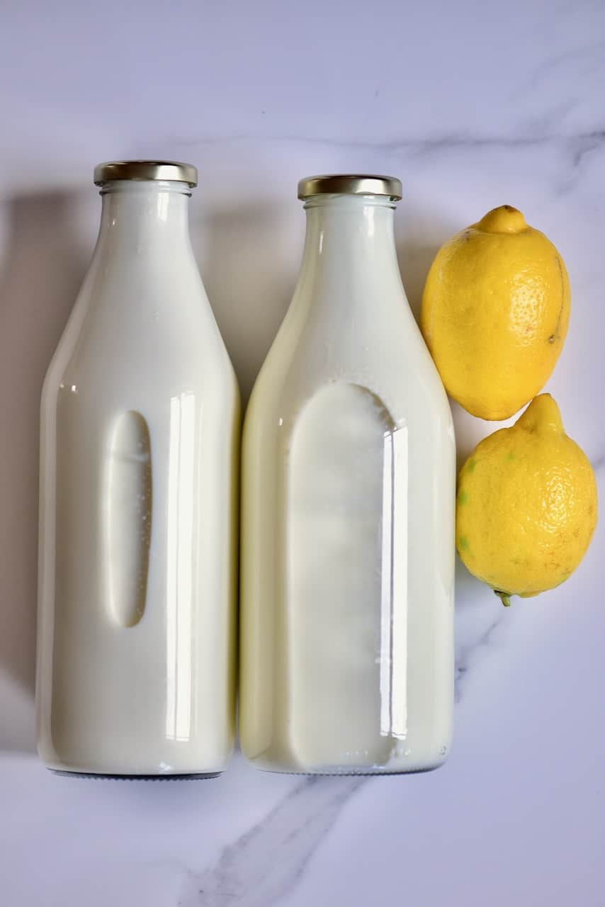 two bottle of milk and two lemons