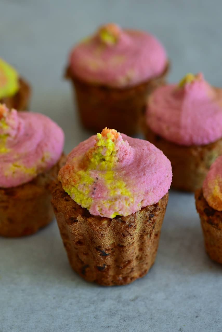 close up of savoury cupcake with rainbow hummus frosting - Sundried Tomato Savoury Muffins & Rainbow Hummus Frosting