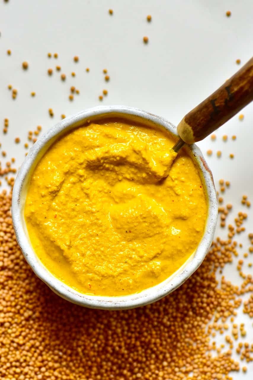 Bowl of mustard and spilled seeds