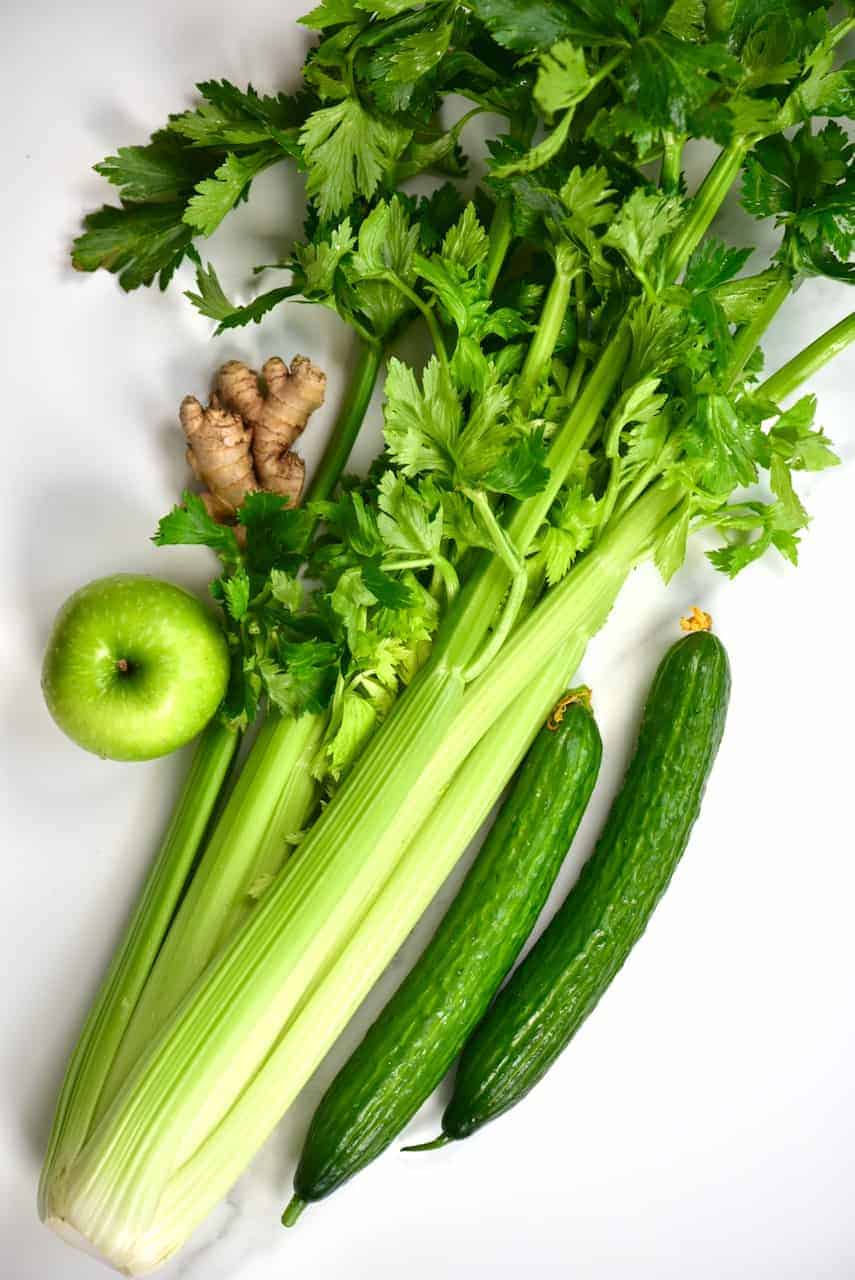 Ingredients for a celery juice with apple and cucumber