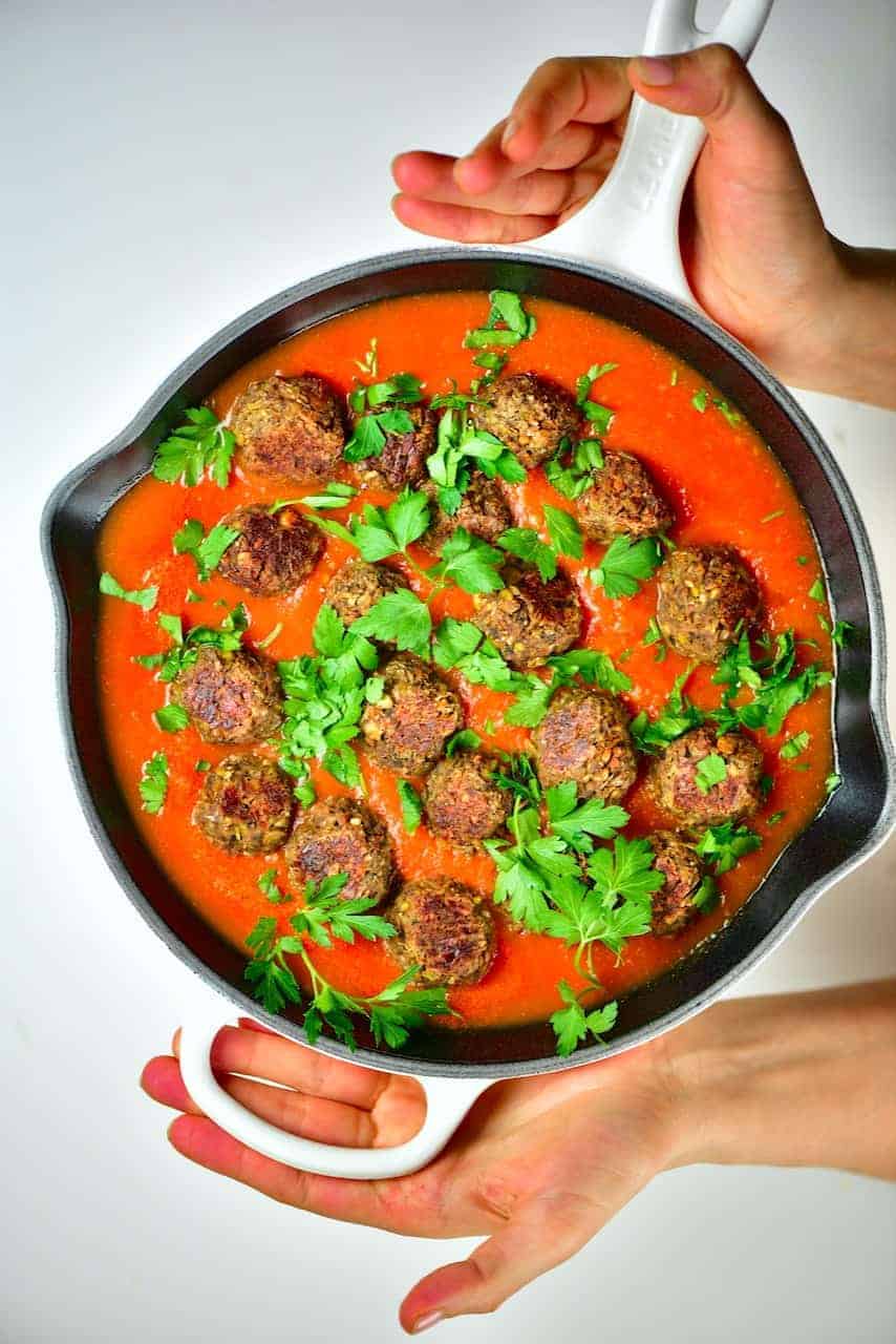 Close up of lentil meatballs with tomato sauce