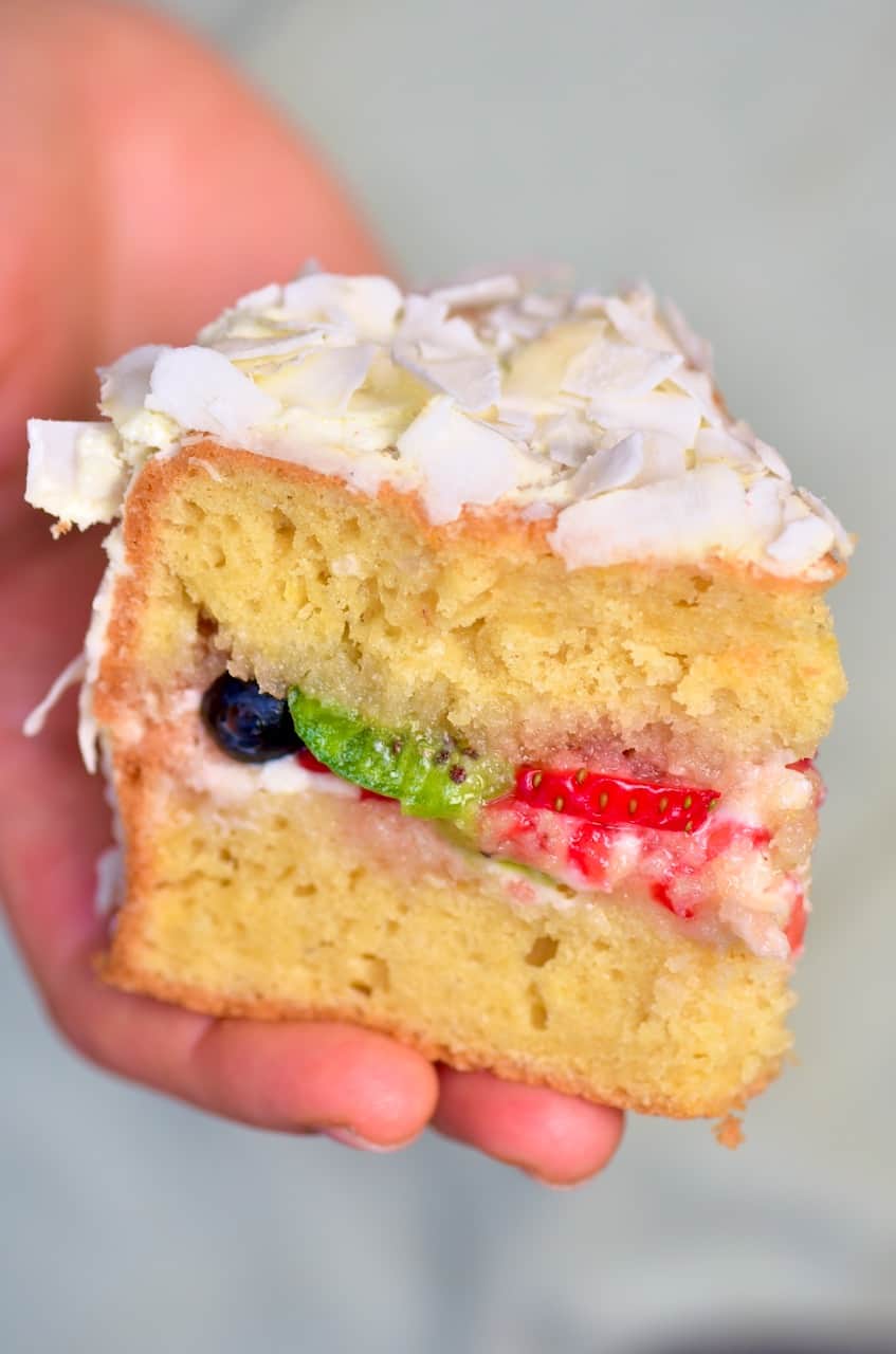 A slice of coconut cream cake with fruit