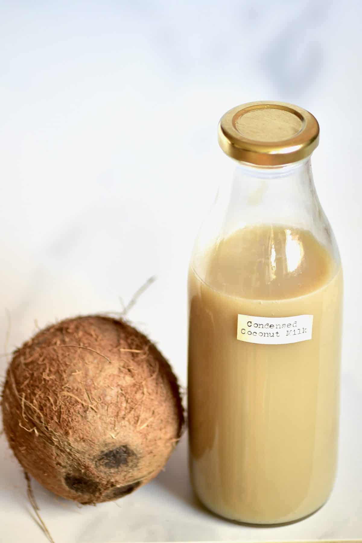 A bottle of condensed coconut milk and a coconut