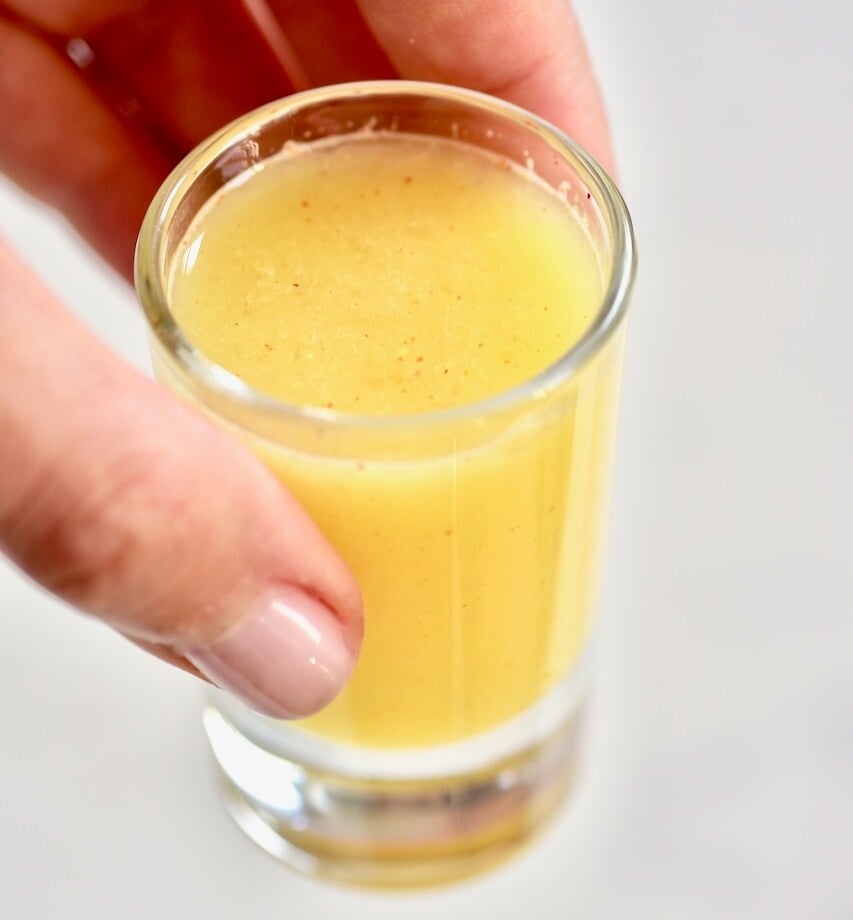 Fresh ginger lemon shot in a small cup.