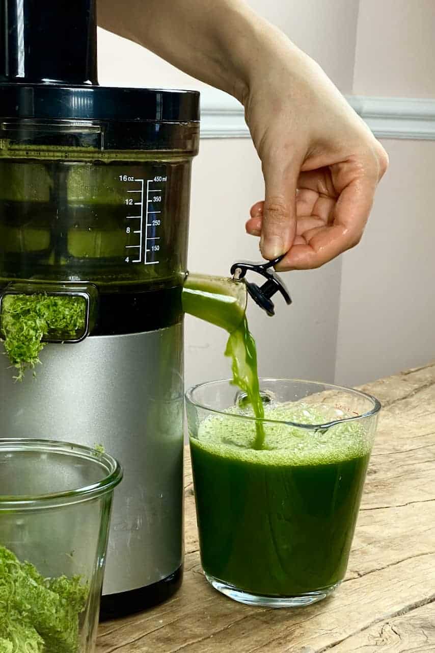 Pouring the celery juice from the juicer 
