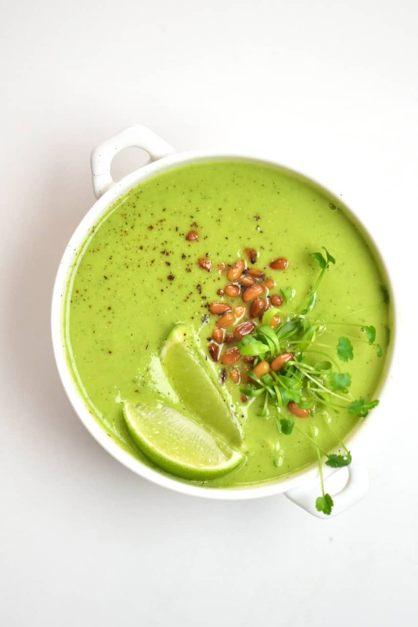 Pea soup topped with lemon and pine nuts