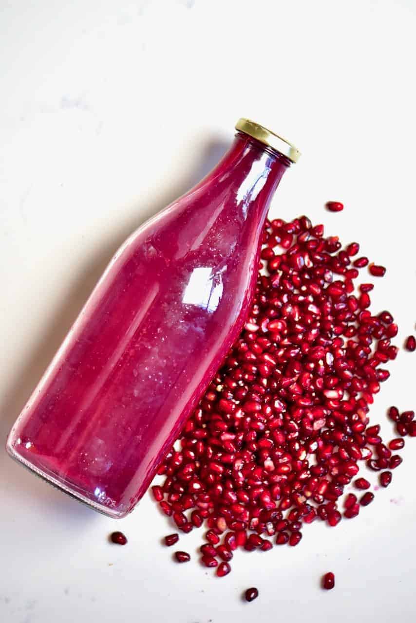 Pomegranate seeds and juice in a bottle