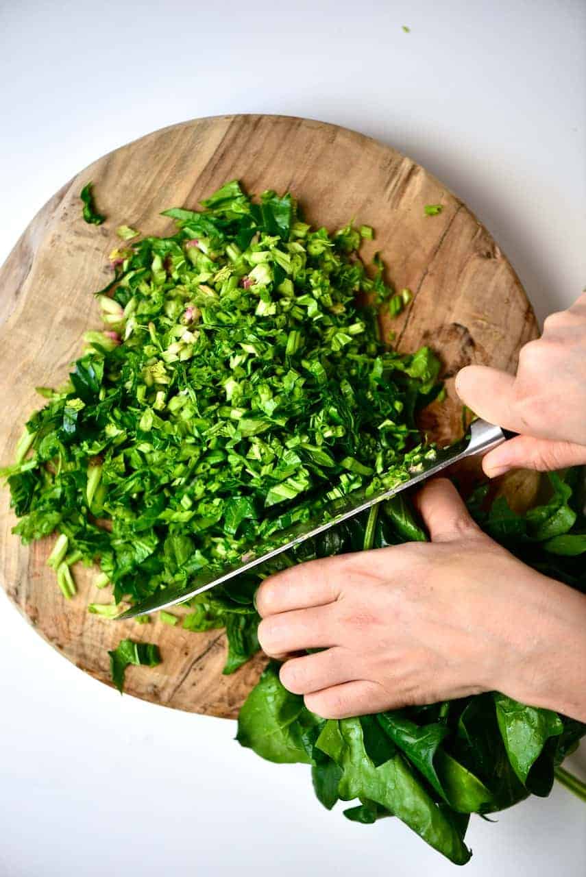 Cutting spinach for Spinach Fatayer