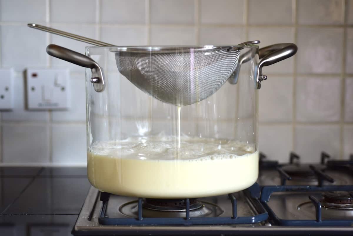 Sifting soy milk for homemade tofu
