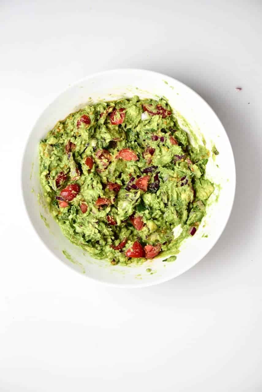 Guacamole and tomatoes bowl