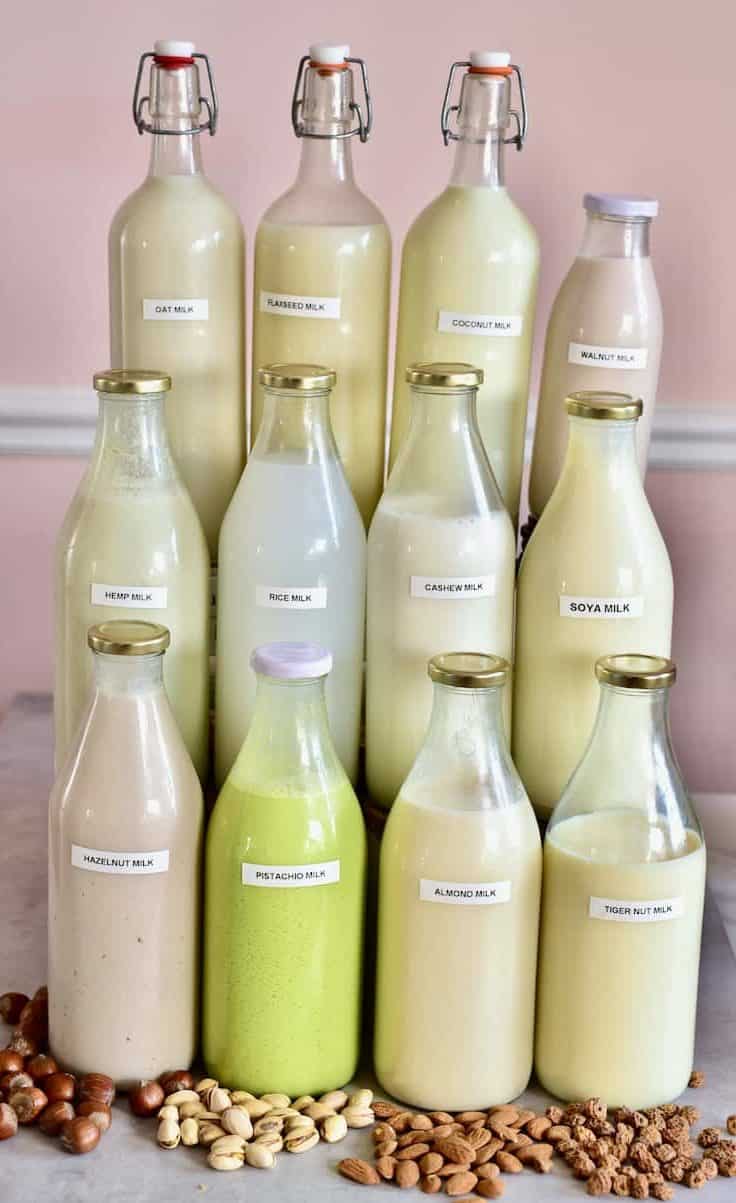 Twelve bottles of homemade plantbased dairy-free milks