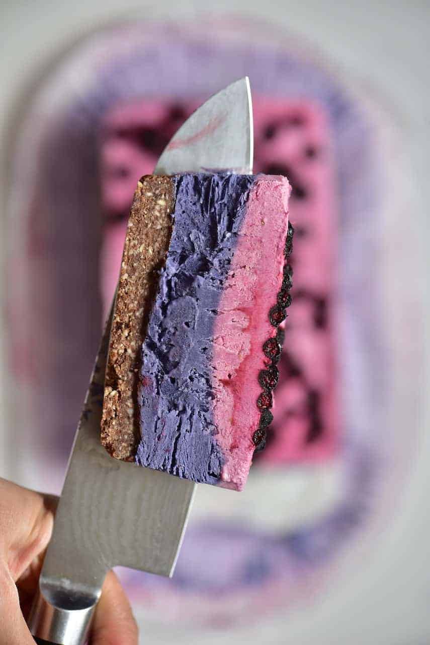 A slice of Berry Raw Dessert on a knife