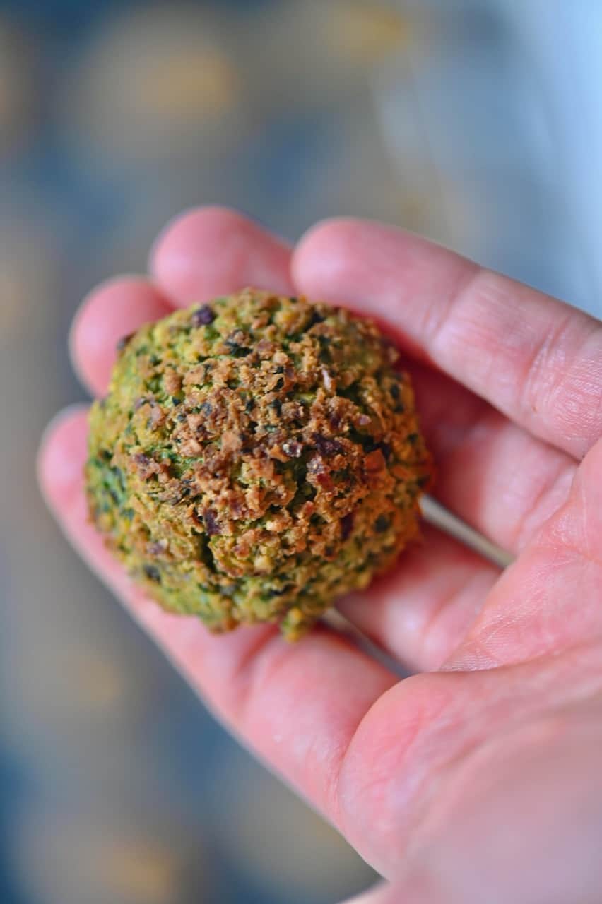 small baked falafel ball on a hand