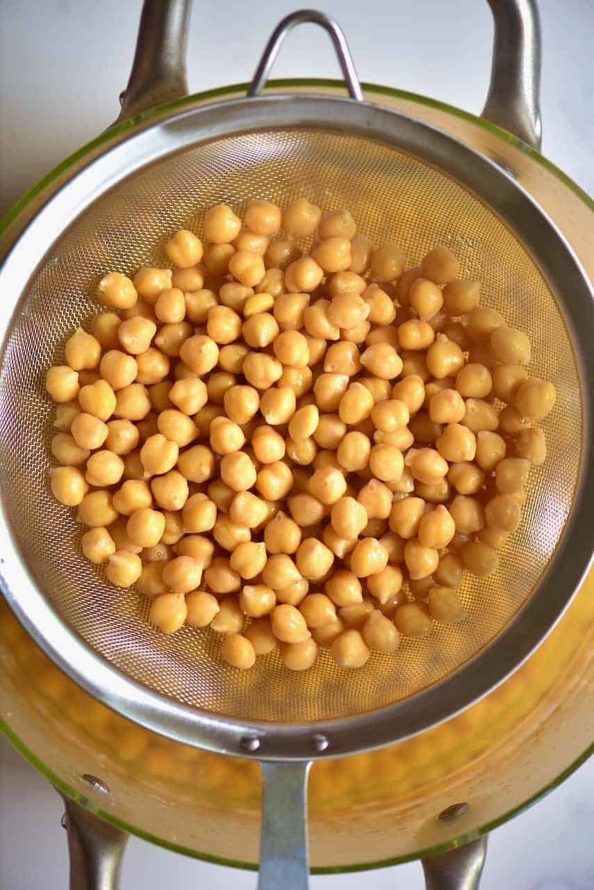 Draining the cooked chickpeas