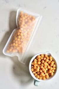 Cooked chickpeas in a cup and freezer bag