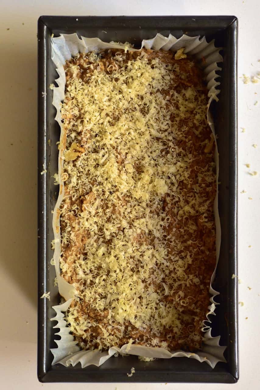 banana bread loaf dough topped with shredded walnuts