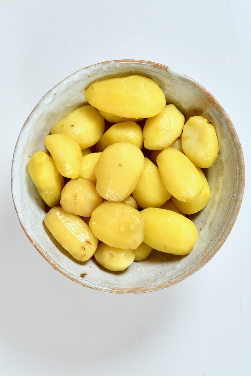 Peeled boiled potatoes in a large bowl