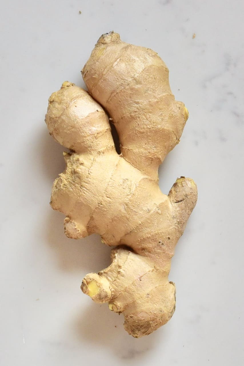 Unpeeled Ginger Root On marble counter