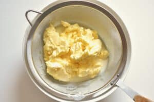 butter and buttermilk in a sieve