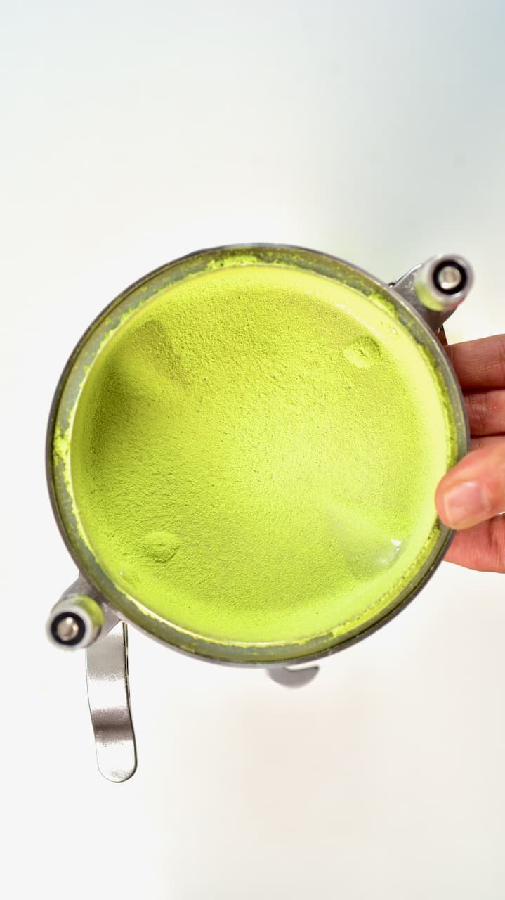 fine green pea powder on grinder lid